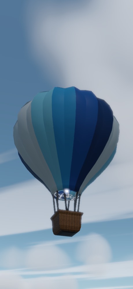 霞んだ真昼の空を背にした、青と灰の濃淡の気球